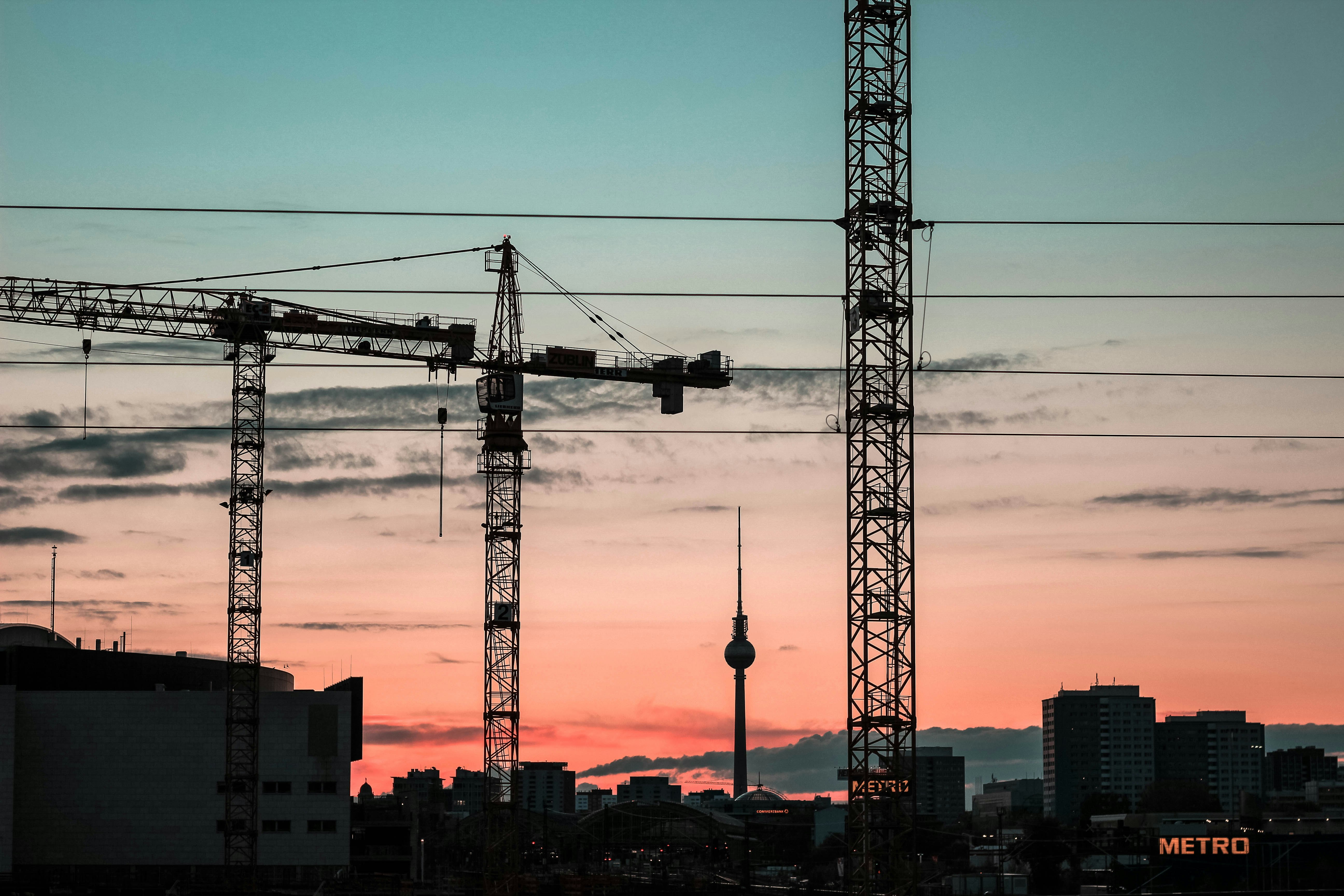 silhouette of crane trucks